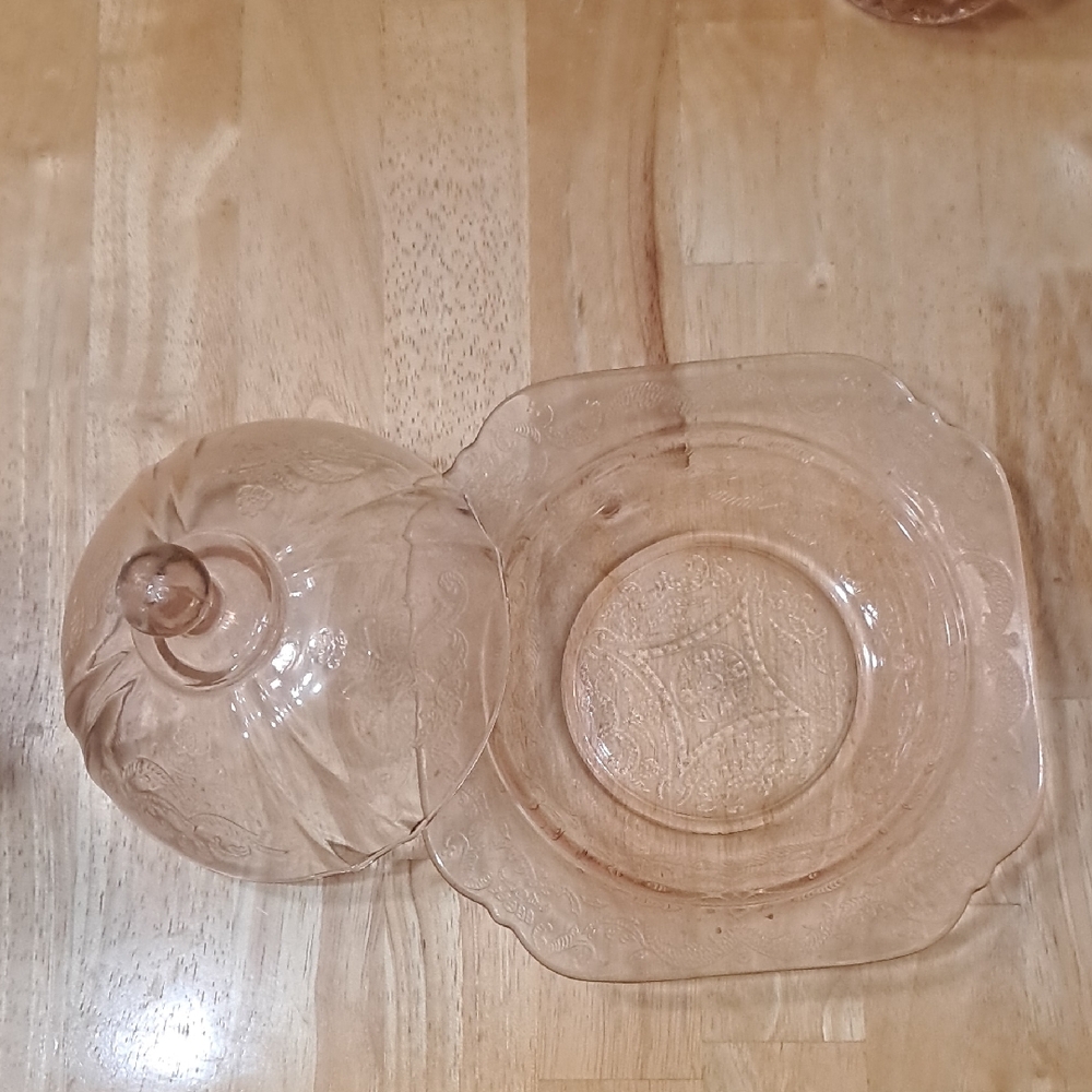 This is a pink depression glass covered butter dish in the Madrid pattern